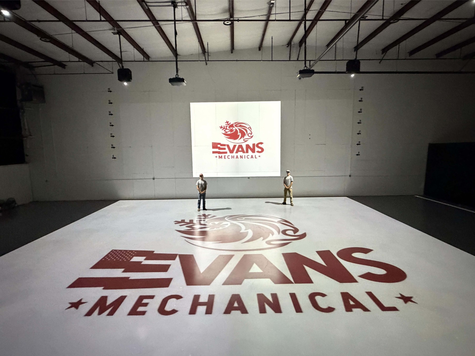 Evans Mechanical team at the Tulsa headquarters with branded floor logo